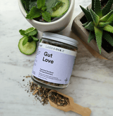 Gut Love Superfood Tea jar with herbs and refreshing ingredients for detox and gut health.