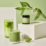 Purely Matcha ceremonial grade matcha powder displayed with drinks showcasing vibrant green colors.