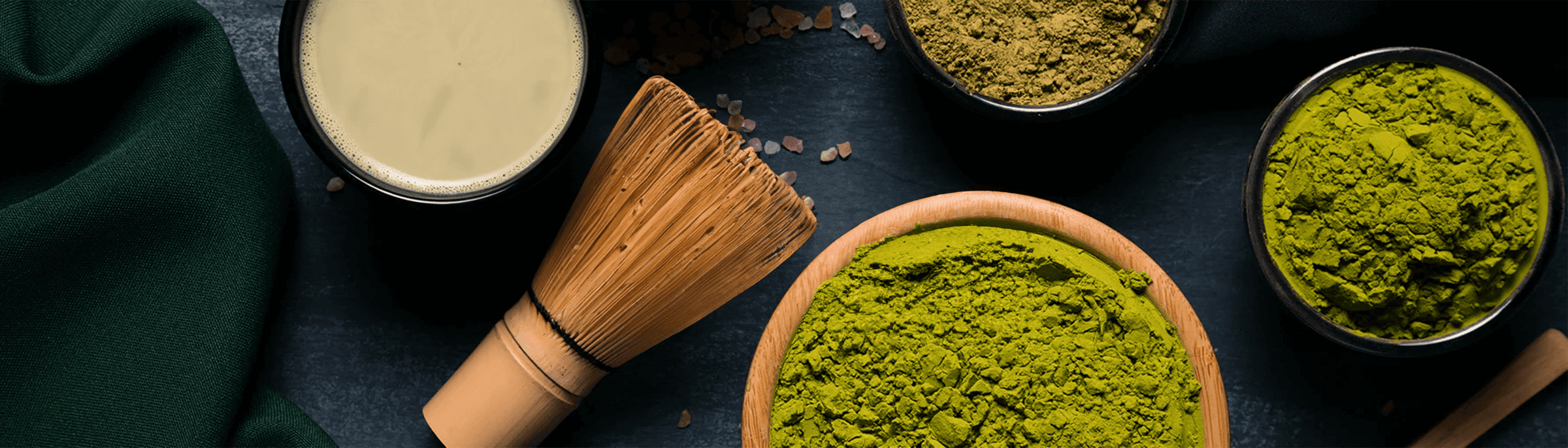 Bowl of vibrant matcha powder and accessories, ready for creating delicious drinks and gifts in Dubai, UAE.