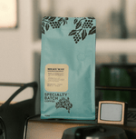 Milky Way Dark Roasted Premium Coffee Blend in Specialty Batch packaging on table