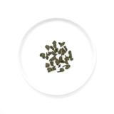 Oolong tea from Fujian, China, hand-rolled and infused with ginseng powder, offering a rich, lingering sweetness in the cup.