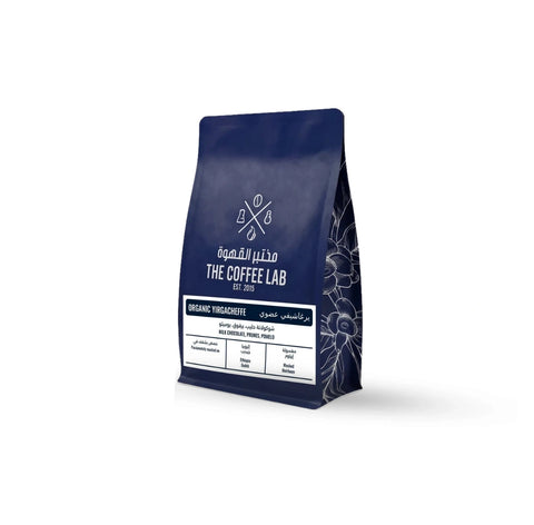 The Coffee Lab Organic Yirgacheffe coffee beans in premium dark blue packaging, featuring Ethiopian specialty coffee with milk chocolate, prune, and pomelo flavor notes.