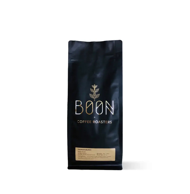 Premium Blend by Boon Coffee Roasters in sleek dark packaging, dark-roasted washed Arabica with bold, layered flavor and clarity, featuring a smooth body and lingering velvety chocolate finish.