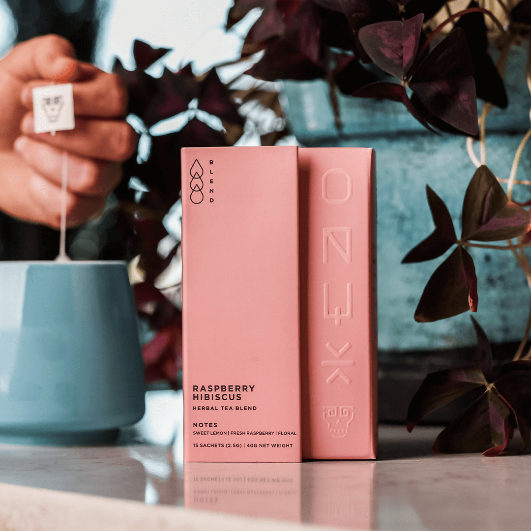 Tart pink herbal tea blend with hibiscus, rose hip, and raspberry leaf, offering a vibrant pink hue, floral aromas, and citrusy finish.