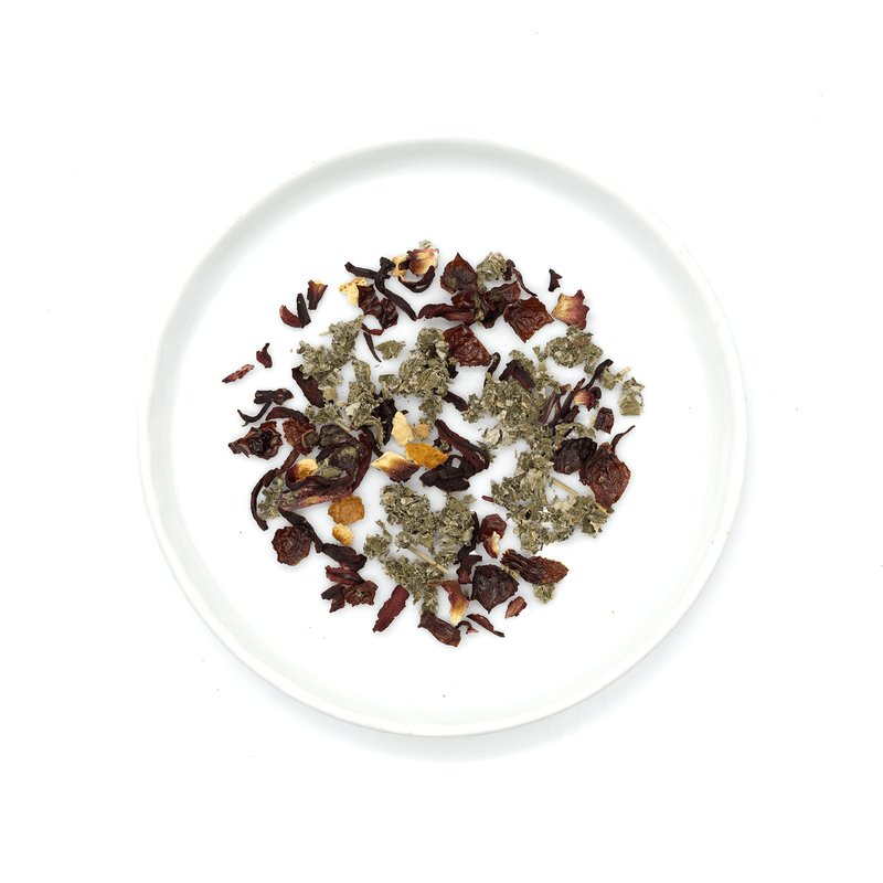 Tart pink herbal tea blend with hibiscus, rose hip, and raspberry leaf, offering a vibrant pink hue, floral aromas, and citrusy finish.