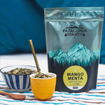 Menta Mango Yerba Mate packaging with two tea cups and a spoon, showcasing premium yerba mate from UAE Argentina.