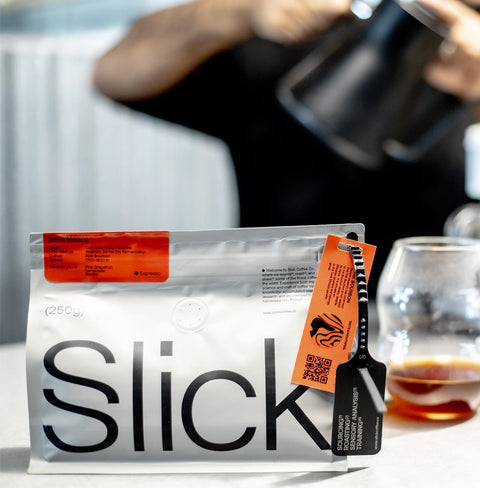 Pack of Sierra Morena Pink Bourbon coffee by Slick Coffee Co. with notes of grapefruit, lemonade, and mixed berries.