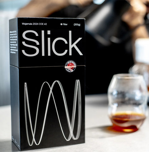 Wajamala COE #2 coffee pack by Slick Coffee Co., featuring award-winning notes of sugarcane, citrus, lemongrass, and currants.
