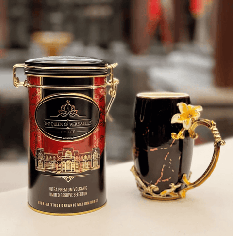 Ultra Premium Volcanic Limited Reserve Medium Roast Ground Coffee can beside an ornate coffee mug on a stylish table.