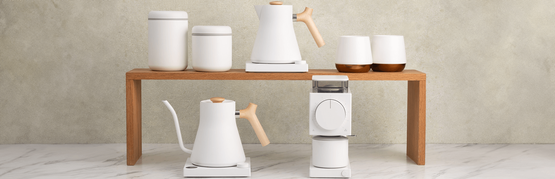 Elegant drinkware and accessories for coffee, tea, and matcha on a wooden shelf, perfect for any UAE gifts or hampers.