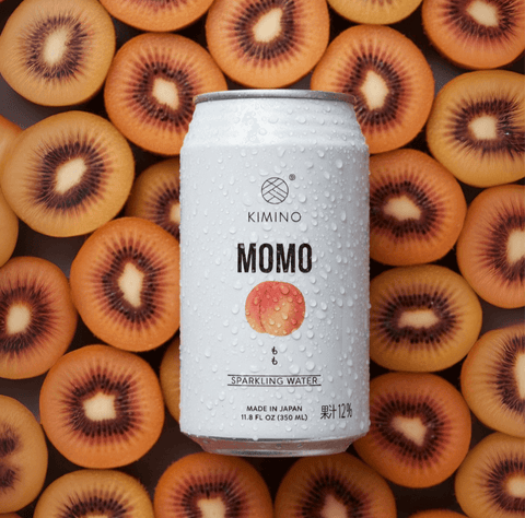 Momo Sparkling Water can with fresh Japanese white peaches and mountain spring water background.