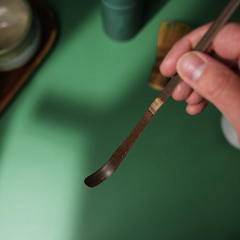 Handmade purple bamboo Matcha scoop (Chashaku) with a rounded J end for perfect matcha measurement. Natural materials.