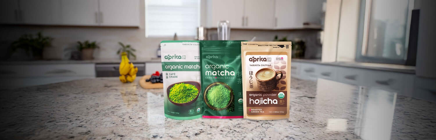 Three packets of organic matcha and hojicha on a kitchen counter, perfect for tea lovers in Dubai, UAE.