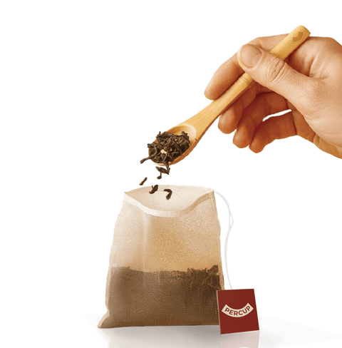 Biodegradable Tea Filters being filled with loose-leaf tea for eco-friendly brewing.
