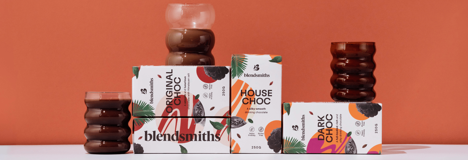 Blendsmiths artisan drinking chocolate collection, featuring Original Choc, House Choc, and Dark Choc blends. Premium, dairy-free, and ethically sourced hot chocolate drinks displayed with elegant glassware against a warm-toned background.
