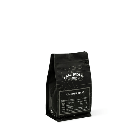 Cafe Rider Roastery's Colombia Decaf coffee with peach, maple syrup, and chocolate notes, decaffeinated using sugarcane E.A. method.