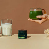 The Ceremonial Matcha Starter Bundle : Gold No.2 with matcha drink and Gold No.2 tin on a beige table.