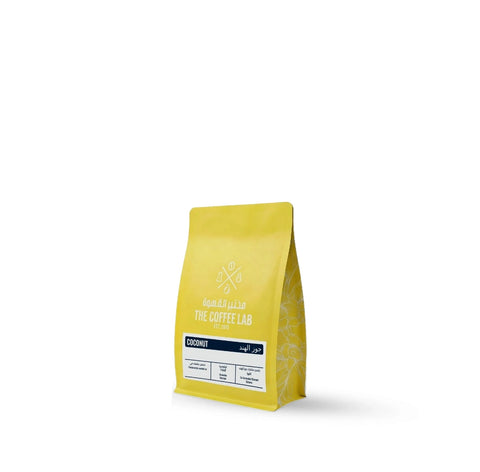 The Coffee Lab Coconut specialty coffee beans from Colombia featuring co-fermented Caturra Arabica coffee in a premium yellow retail bag.