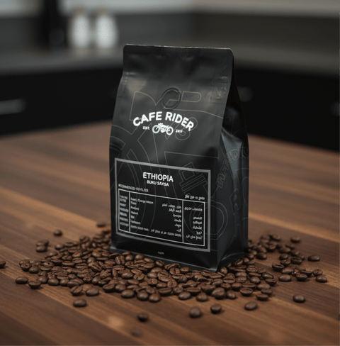 Ethiopia Buku Sayisa coffee bag surrounded by coffee beans on wooden surface, highlighting premium organic Ethiopian heirloom coffee.