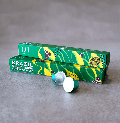 Brazil - Coffee Capsules showcasing premium Brazilian coffee in green packaging on a grey surface.