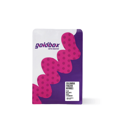Bag of Colombia Frozen Berries Specialty Coffee with purple and pink design from Goldbox Coffee Roastery