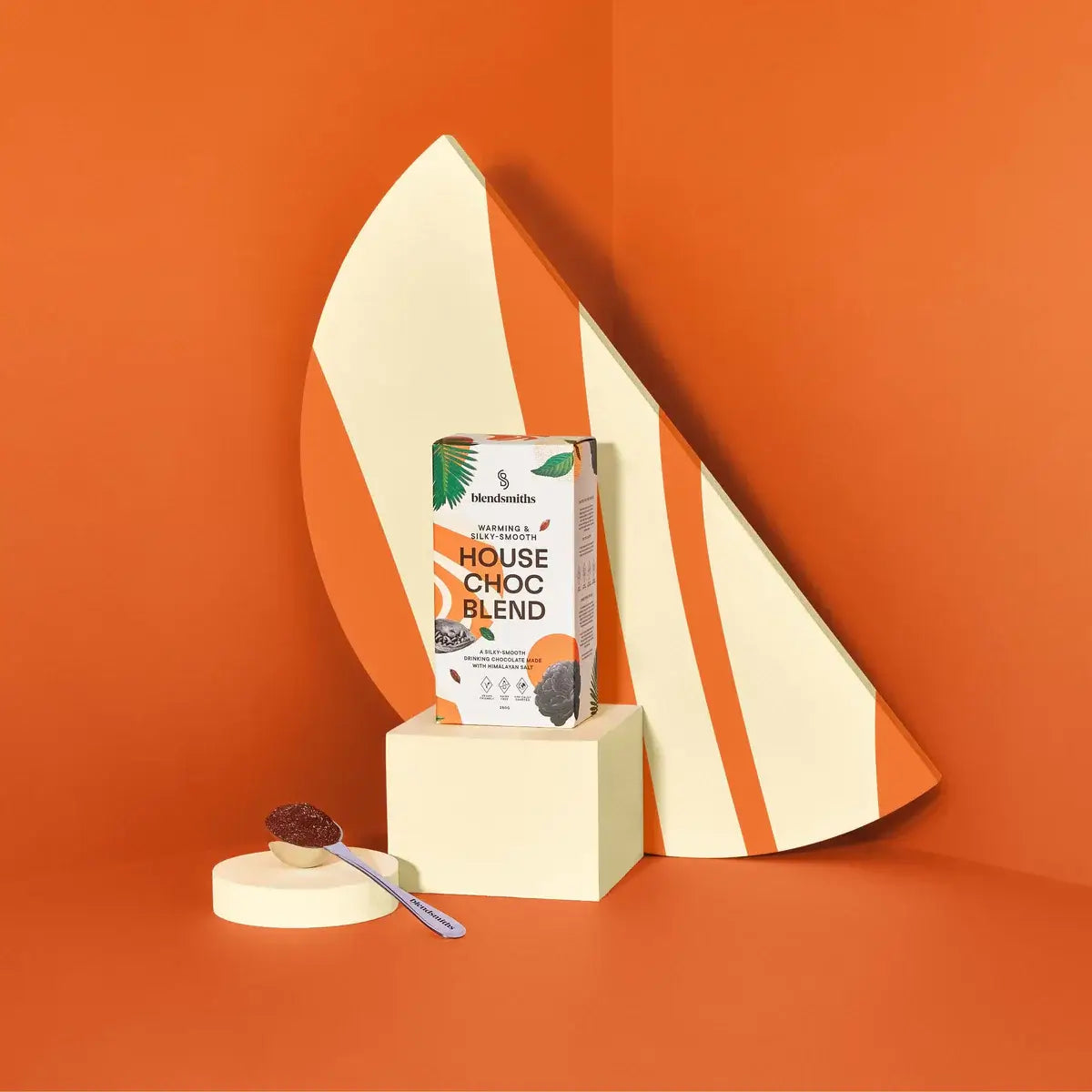 Blendsmiths House Choc Blend packaging, featuring a warm and silky-smooth drinking chocolate made with Himalayan salt. The box has a modern design with earthy tones, abstract patterns, and botanical elements, highlighting its vegan-friendly, dairy-free, a