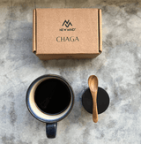 A top view of a mug of Crystal Black Chaga Extract alongside its packaging, showcasing its rich color and natural appeal.