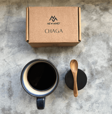A top view of a mug of Crystal Black Chaga Extract alongside its packaging, showcasing its rich color and natural appeal.