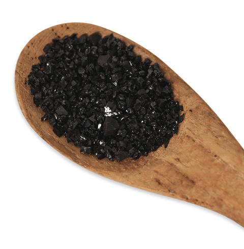 Crystal Black Chaga Extract in a wooden spoon showcasing its rich texture and unique color.