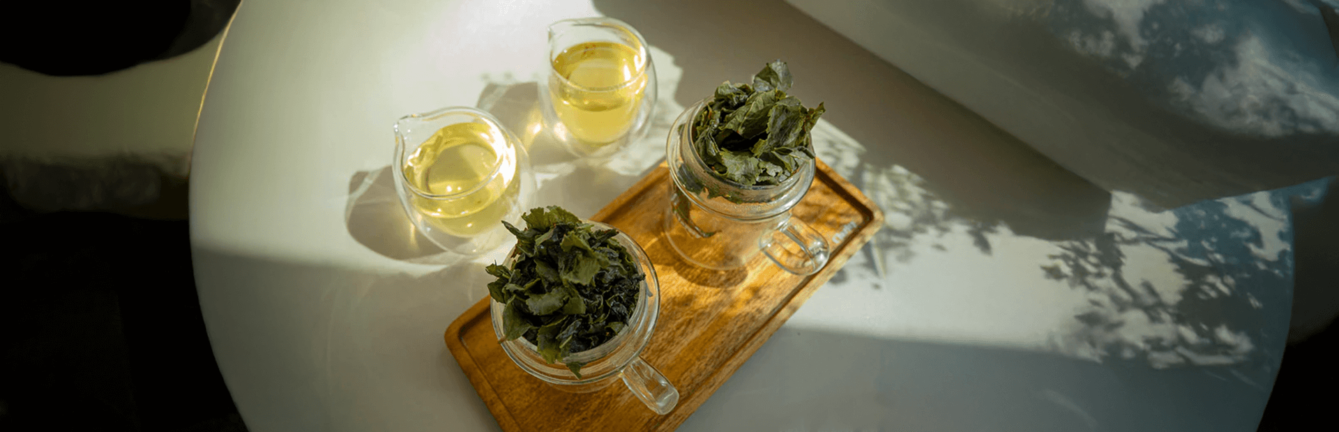 Herbal tea and fresh leaves served in elegant glassware, perfect for a calming drink experience in Dubai.