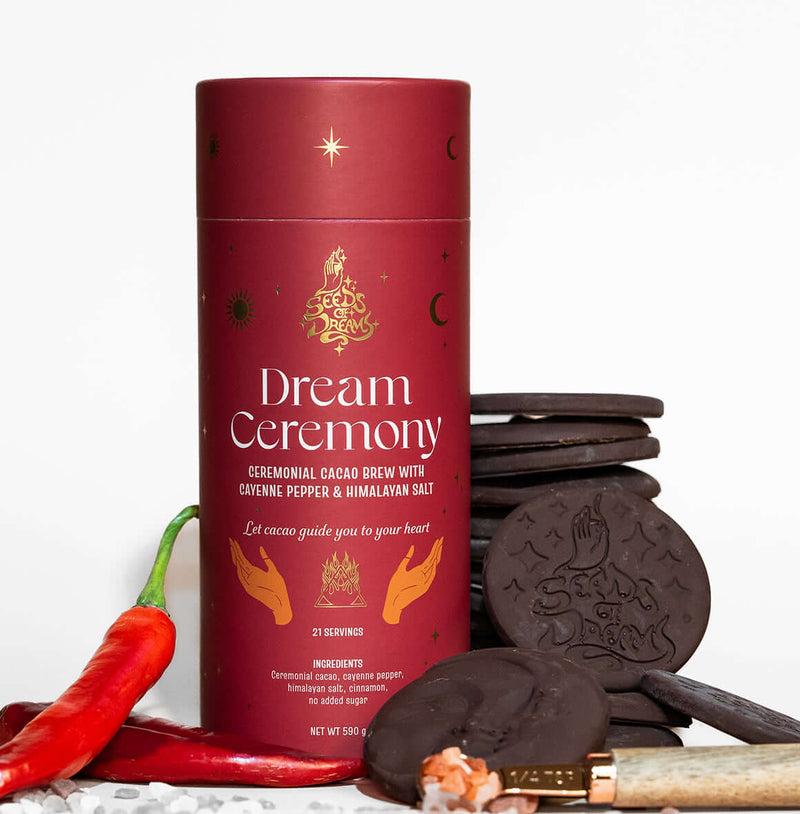 Dream Ceremony ceremonial cacao brew packaging with Cayenne Pepper & Himalayan Salt, featuring a bold red design with celestial gold accents.