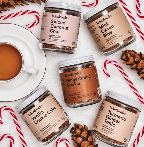 Image of various tea jars including Ginger Bread Cookies, surrounded by candy canes and a cup of tea.
