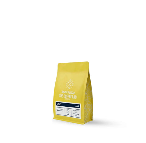 The Coffee Lab Grape specialty coffee beans from Colombia in a yellow retail bag featuring Caturra coffee processed using grape co-fermentation.