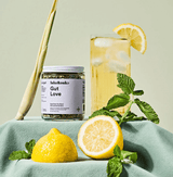Gut Love Superfood Tea jar with lemons and mint, refreshing beverage, inflammation-taming detox blend.