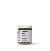 Gut Love Superfood Tea in a glass jar, a blend for detoxifying and relieving bloating.