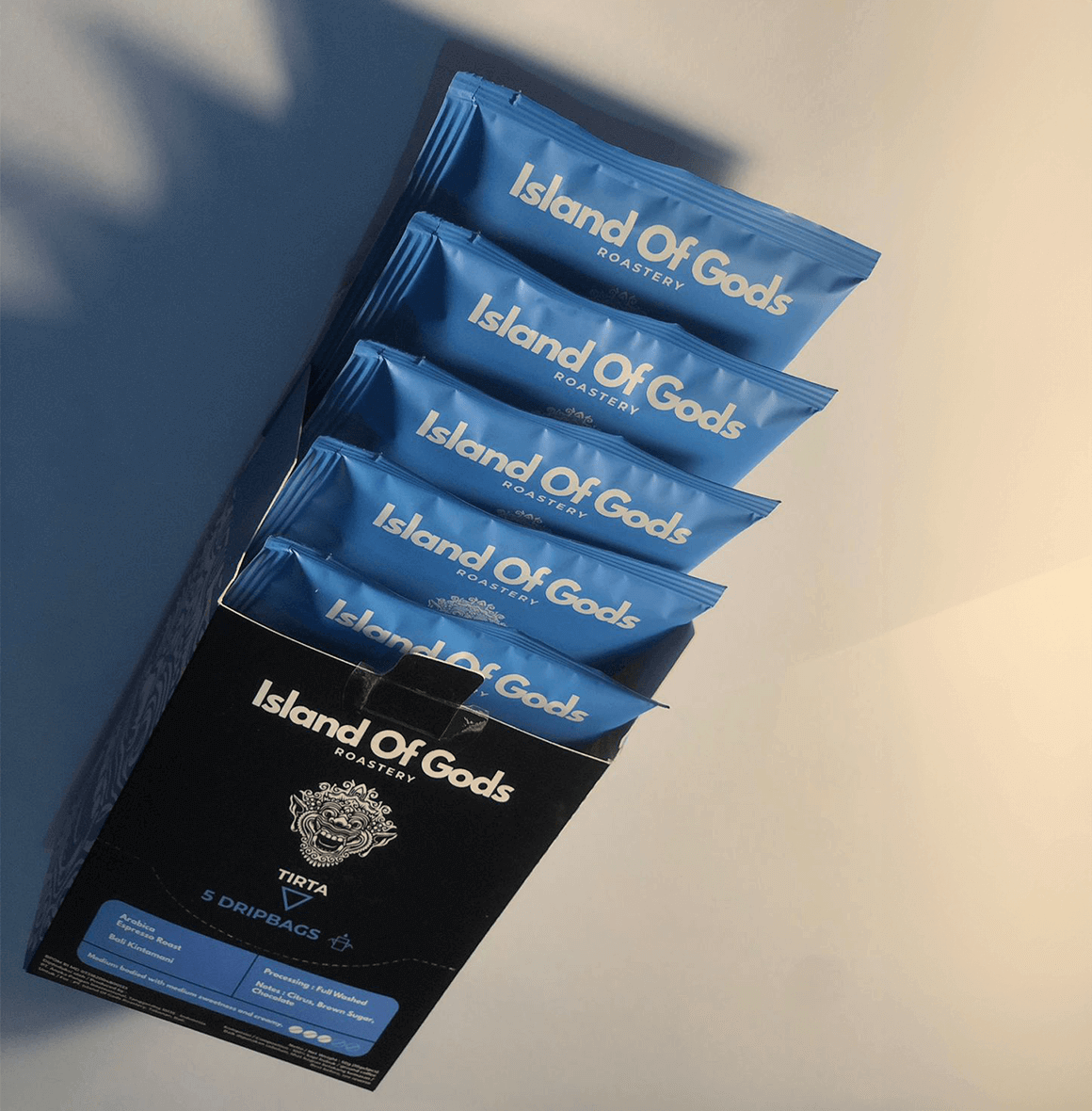 TIRTA Drip Bag coffee packaging featuring vibrant blue bags from Island of Gods, ideal for a flavorful brew.