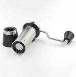 Professional coffee grinder with 47mm Black-Fusion conical burrs, smooth ball-bearing mechanism, stainless steel catch-cup, magnetic funnel, and EVA travel case for on-the-go brewing.