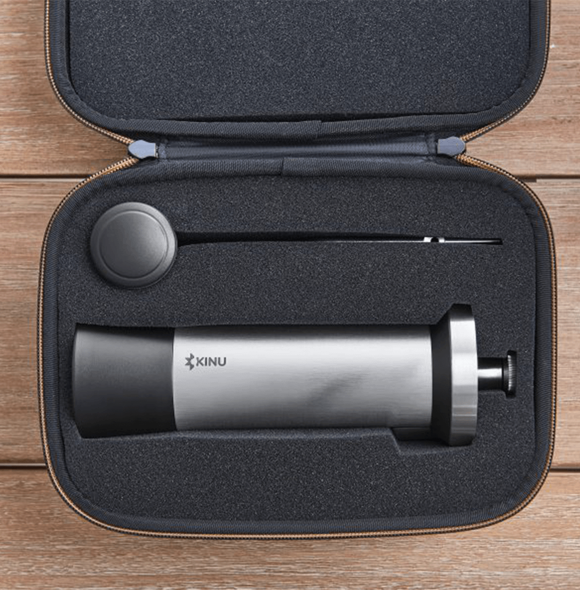 Professional coffee grinder with 47mm Black-Fusion conical burrs, smooth ball-bearing mechanism, stainless steel catch-cup, magnetic funnel, and EVA travel case for on-the-go brewing.