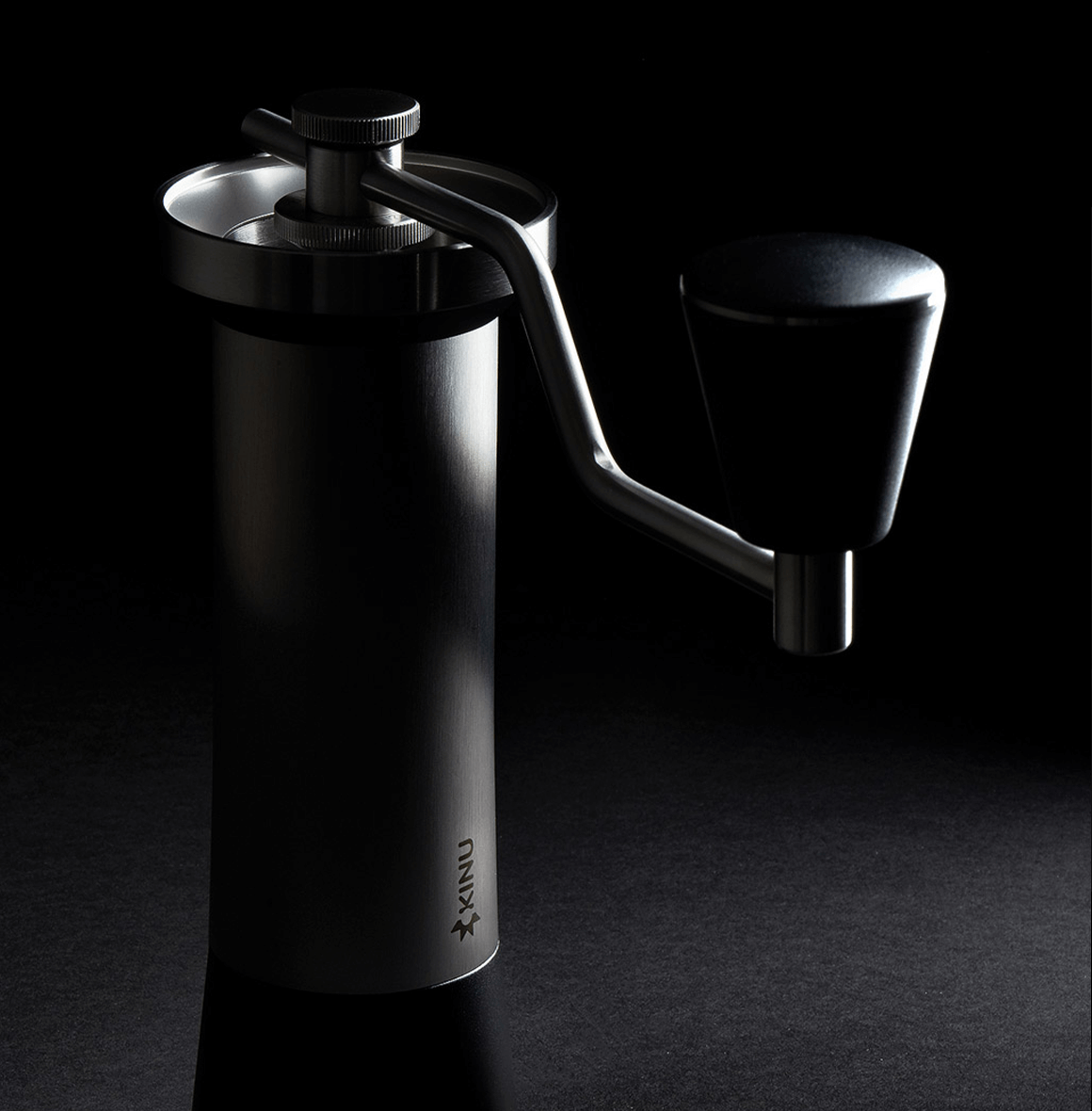 Professional coffee grinder with 47mm Black-Fusion conical burrs, smooth ball-bearing mechanism, stainless steel catch-cup, magnetic funnel, and EVA travel case for on-the-go brewing.