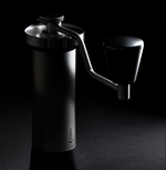 Professional coffee grinder with 47mm Black-Fusion conical burrs, smooth ball-bearing mechanism, stainless steel catch-cup, magnetic funnel, and EVA travel case for on-the-go brewing.