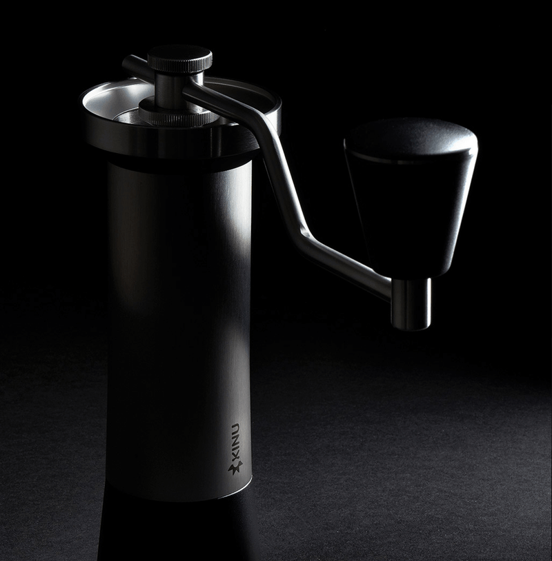 Professional coffee grinder with 47mm Black-Fusion conical burrs, smooth ball-bearing mechanism, stainless steel catch-cup, magnetic funnel, and EVA travel case for on-the-go brewing.