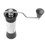 Kinu manual coffee grinder with 47mm Black-Fusion conical burrs, smooth ball-bearing mechanism, and EVA travel case, engineered for speed, precision, and portability.