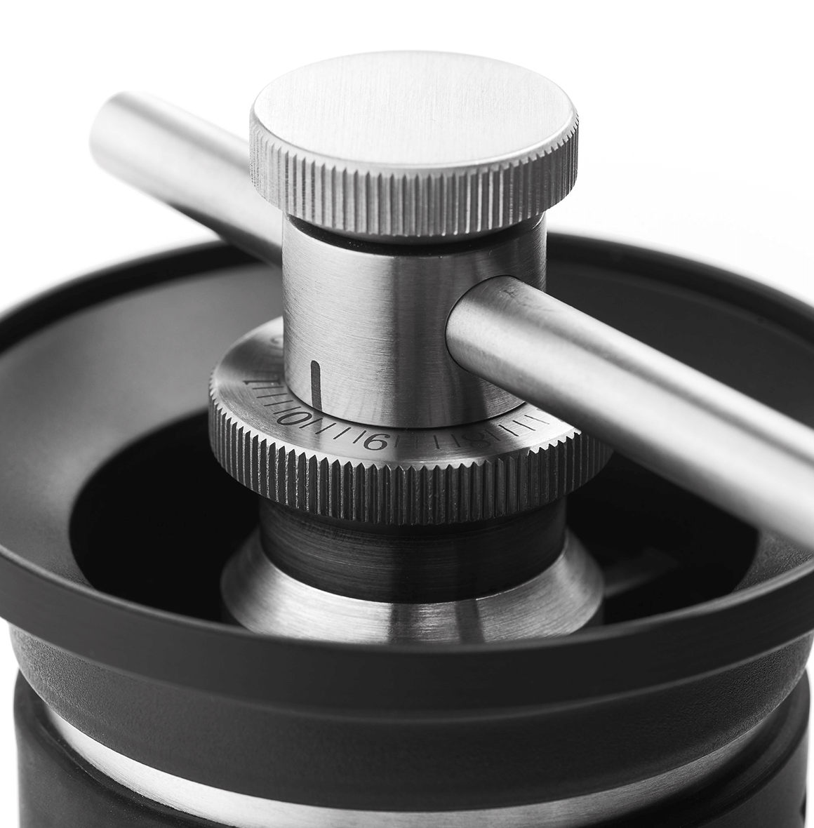 Kinu manual coffee grinder with 47mm Black-Fusion conical burrs, smooth ball-bearing mechanism, and EVA travel case, engineered for speed, precision, and portability.