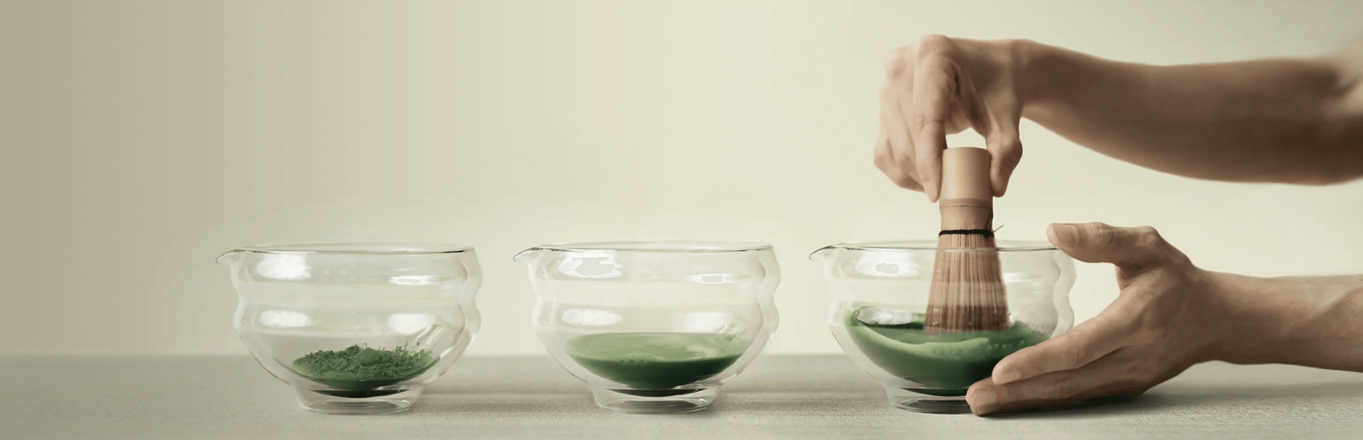 Preparing matcha powder in glass bowls, showcasing tea accessories for a delightful drink experience in Dubai.