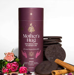 Mother’s Hug cacao brew packaging with a warm maroon design, featuring celestial gold details and spiritual hand illustrations.