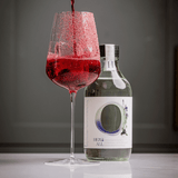 Herb All botanical drink with red cocktail in a glass, highlighting sophisticated non-alcoholic beverage options.
