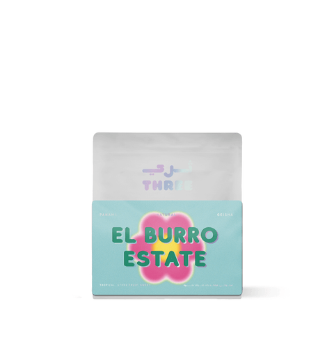 Panama El Burro Geisha Natural by Three Coffee in elegant packaging, grown at 1700–1950 masl by the Lamastus Family on Volcán Barú slopes, with jasmine, mango & bergamot notes in a rich, honey-like body.