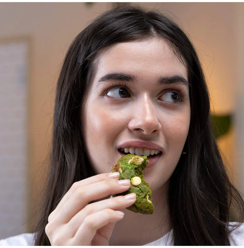 Emerald Matcha ceremonial-grade tea with vivid green color and smooth umami flavor, shown in a woman enjoying a matcha pastry