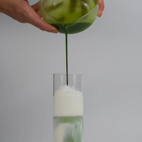 Emerald Matcha ceremonial-grade tea poured into a glass, vivid green and smooth, from Uji first flush harvest
