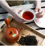 100 years old Wakōcha (Japanese Black Tea) brewed in a cup with teapot and loose leaves